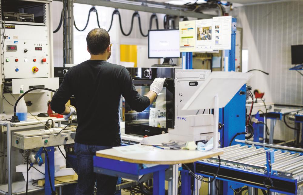 Workers operating a home appliance production line